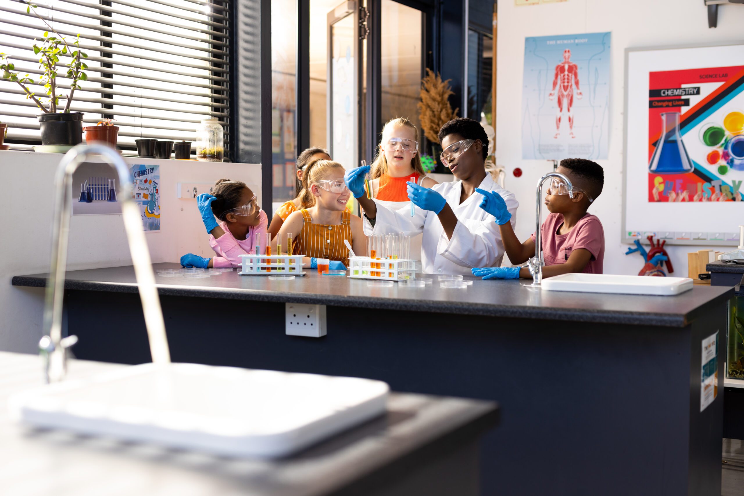 young african american scientist looking through microscope while working in laboratory