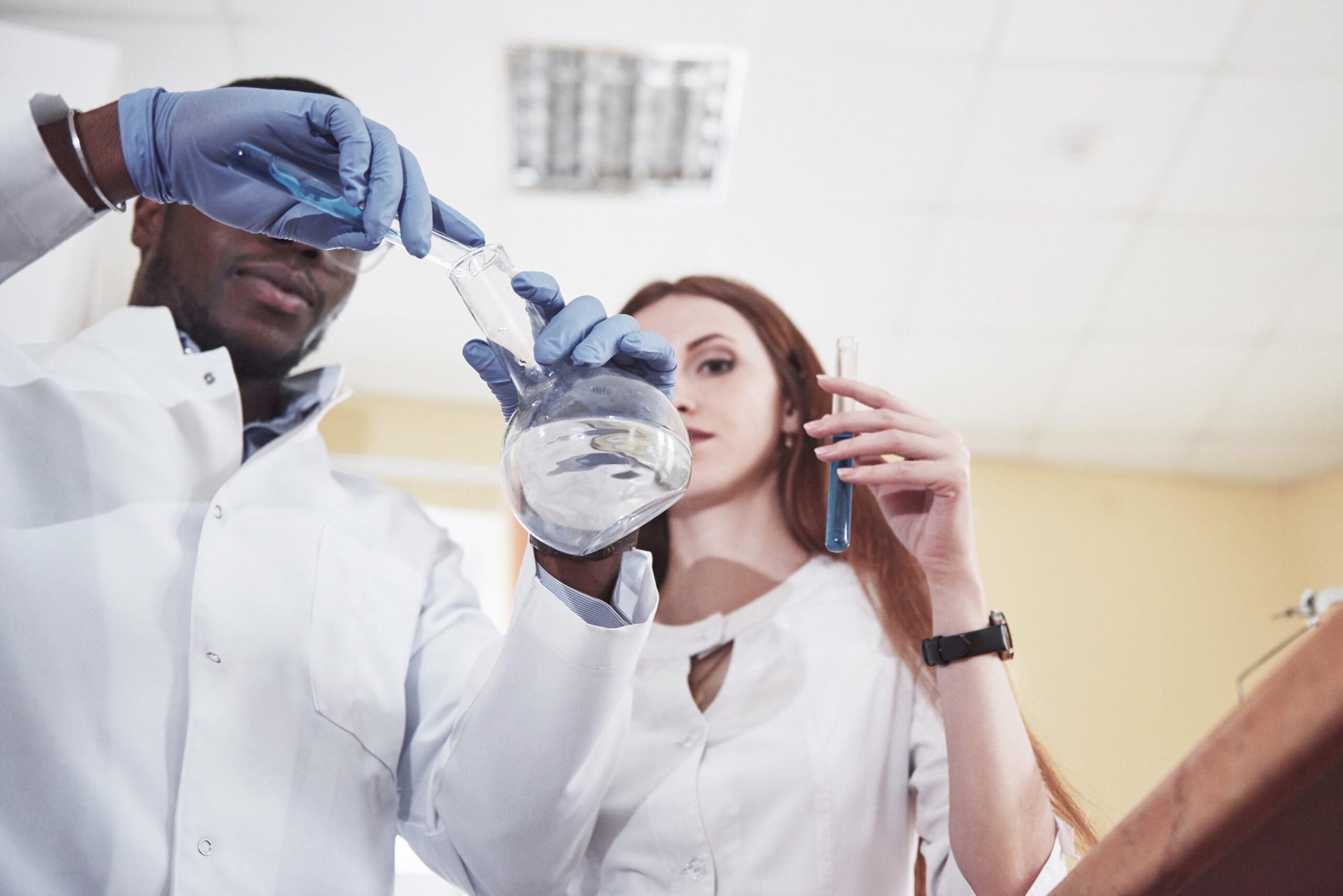 Science, black woman and pipette with tube for test, research and investigation in laboratory. Female scientist working with dropper to study liquid sample, review solution and innovation of vaccine<br />
